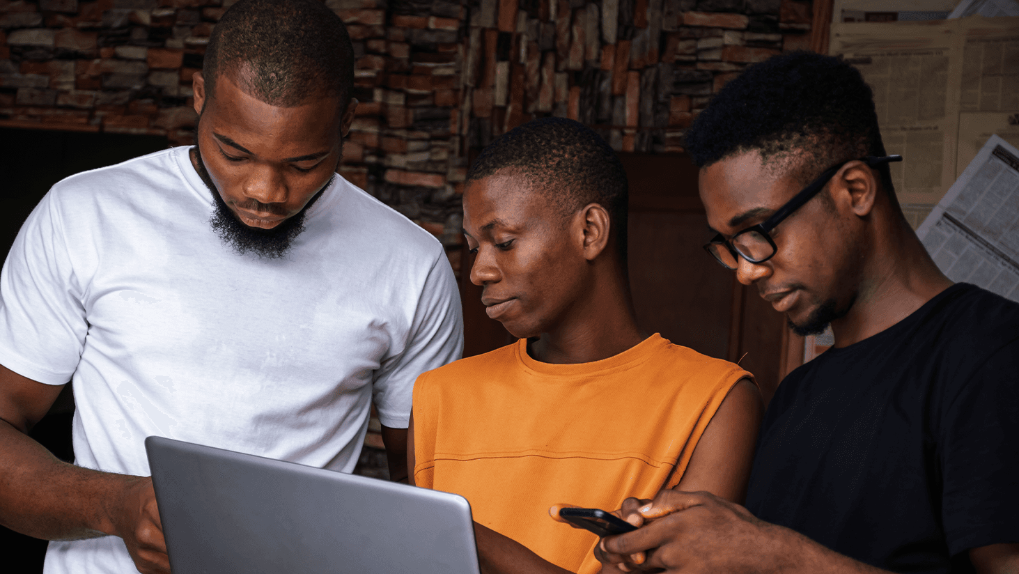 IDE Malawi team working on a laptop